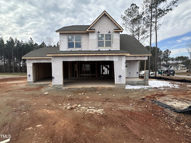 unfinished property featuring a garage and covered porch