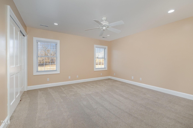 carpeted spare room with ceiling fan