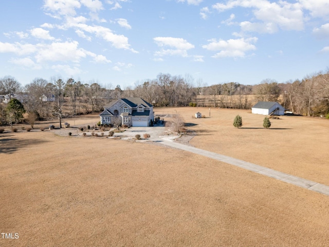 view of yard with a rural view and a garage