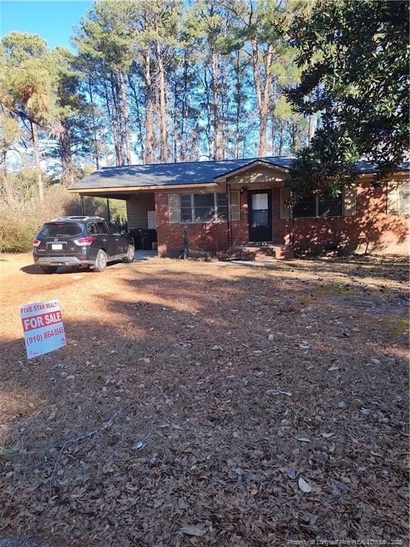 ranch-style house with an attached carport