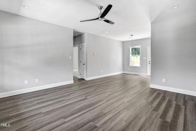 unfurnished living room featuring ceiling fan and dark hardwood / wood-style flooring