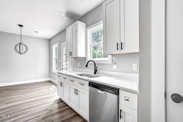 kitchen with sink, dishwasher, dark hardwood / wood-style floors, white cabinets, and decorative light fixtures