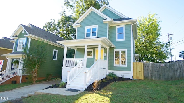 view of front of house featuring covered porch and a front lawn