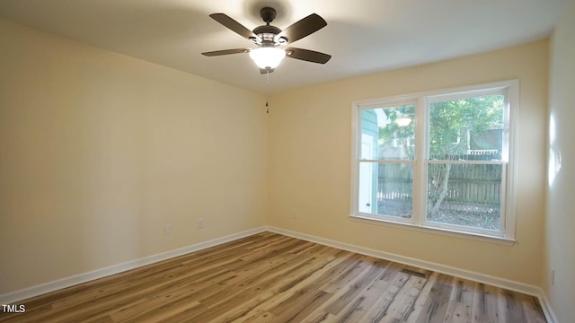 spare room featuring ceiling fan and light wood-type flooring