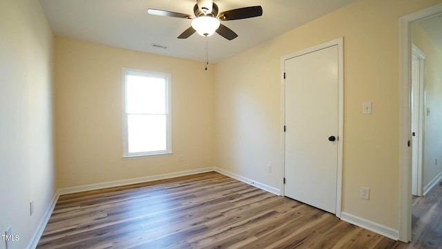 empty room featuring ceiling fan and light hardwood / wood-style flooring