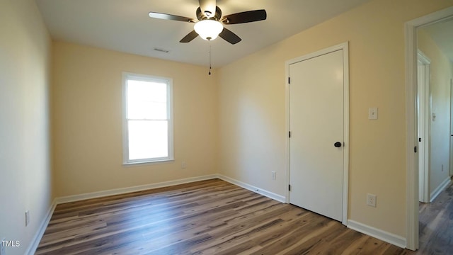 unfurnished bedroom featuring hardwood / wood-style flooring and ceiling fan