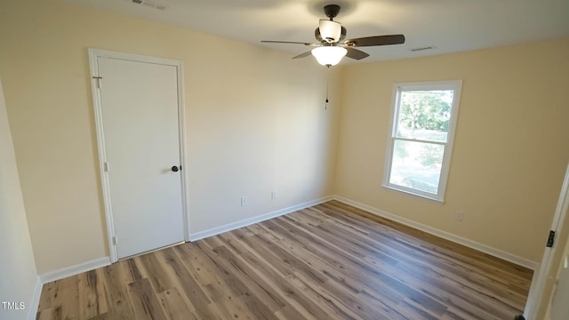 empty room featuring ceiling fan and light wood-type flooring