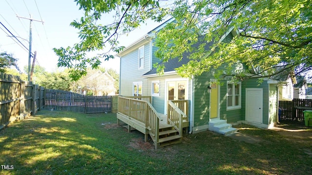 rear view of property featuring a yard