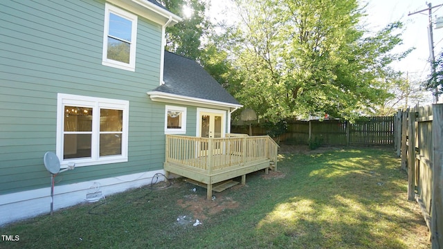 view of yard with a wooden deck and french doors