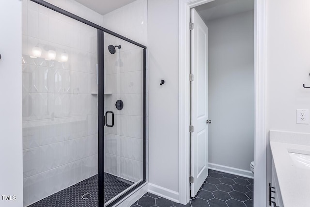 bathroom with walk in shower, tile patterned floors, toilet, and vanity