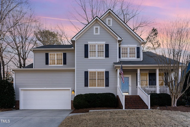 front of property featuring a garage and covered porch