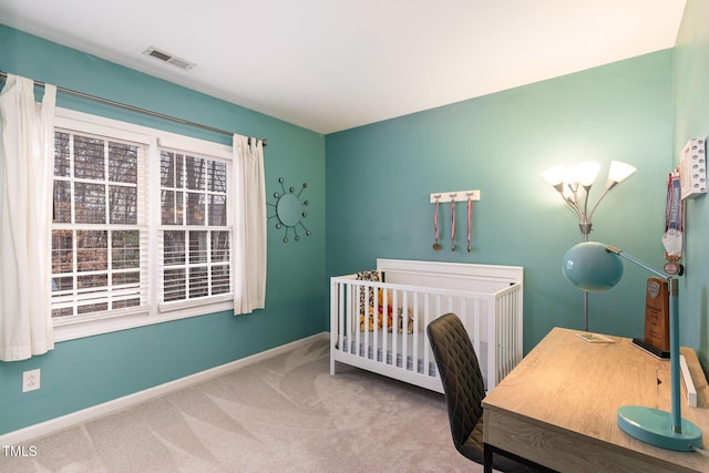 bedroom featuring multiple windows, a nursery area, and carpet