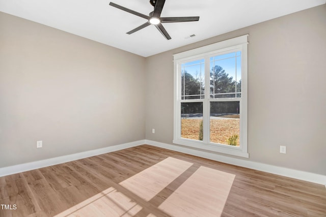 spare room with ceiling fan, a healthy amount of sunlight, and light wood-type flooring