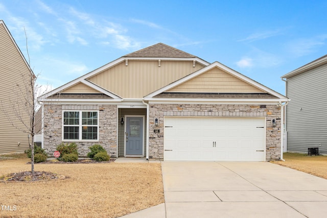 craftsman-style home with a garage and a front lawn