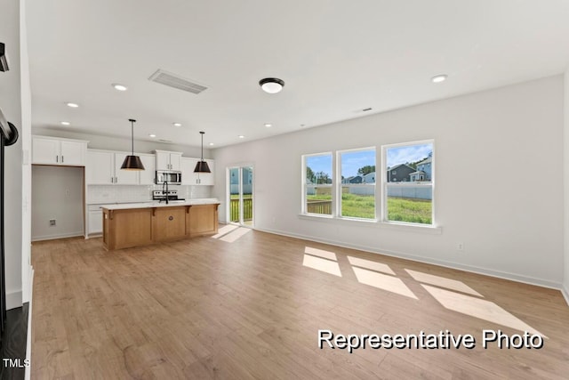 unfurnished living room with light hardwood / wood-style flooring