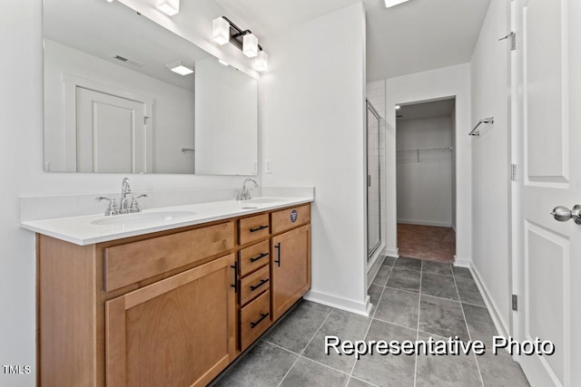 bathroom with vanity and a shower with shower door