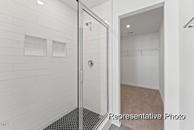 bathroom featuring a shower with shower door