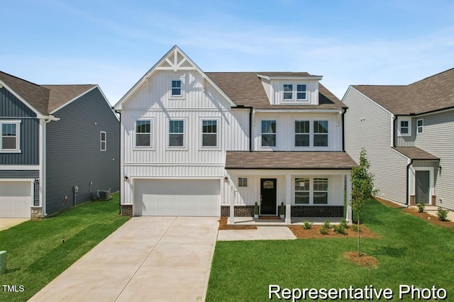 view of front of property with board and batten siding, a front yard, concrete driveway, and an attached garage