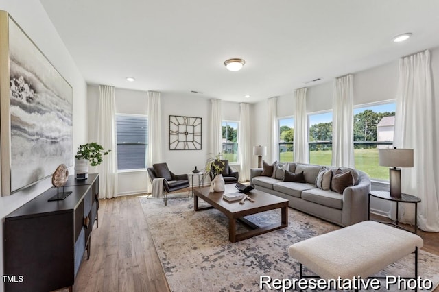 living area featuring recessed lighting and light wood-style floors