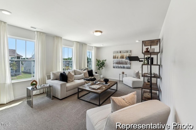 carpeted living area featuring baseboards