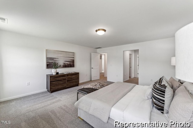 bedroom with baseboards, visible vents, and light colored carpet