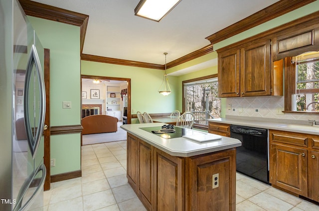 kitchen with freestanding refrigerator, a sink, black dishwasher, crown molding, and a center island