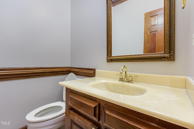 half bath with vanity and toilet