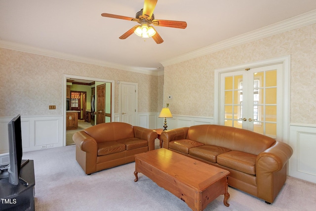 living area with french doors, light colored carpet, wainscoting, and wallpapered walls