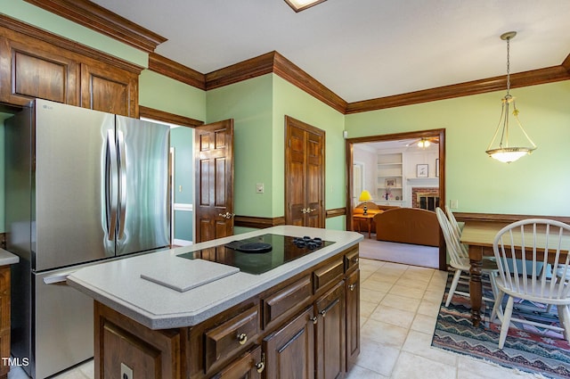 kitchen featuring black electric cooktop, ceiling fan, light countertops, and freestanding refrigerator