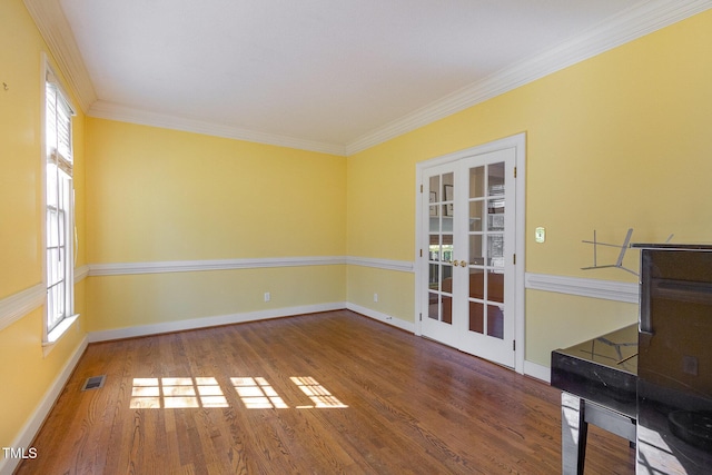 unfurnished room with ornamental molding, french doors, baseboards, and wood finished floors