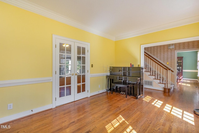 interior space featuring visible vents, stairs, ornamental molding, french doors, and wood finished floors