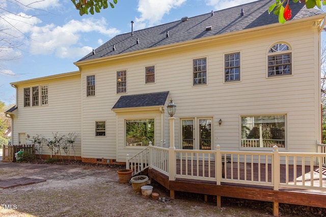 back of house featuring a deck and roof with shingles