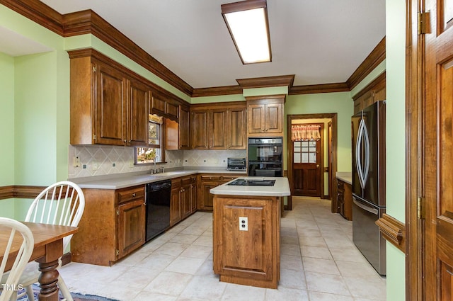 kitchen with a kitchen island, a toaster, black appliances, light countertops, and crown molding