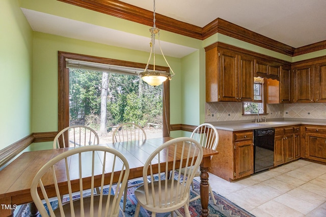 kitchen featuring tasteful backsplash, light countertops, black dishwasher, and a sink