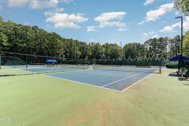 view of sport court featuring fence