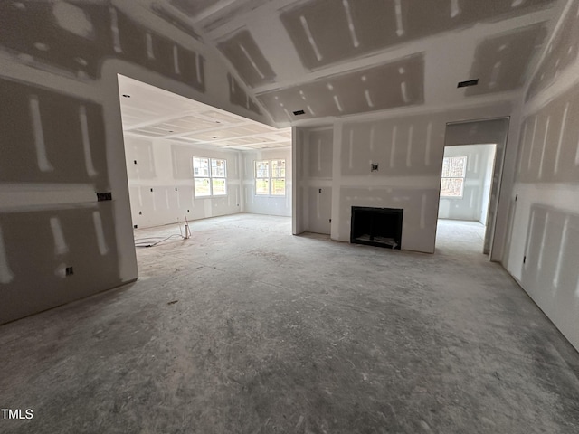 unfurnished living room with a fireplace and visible vents