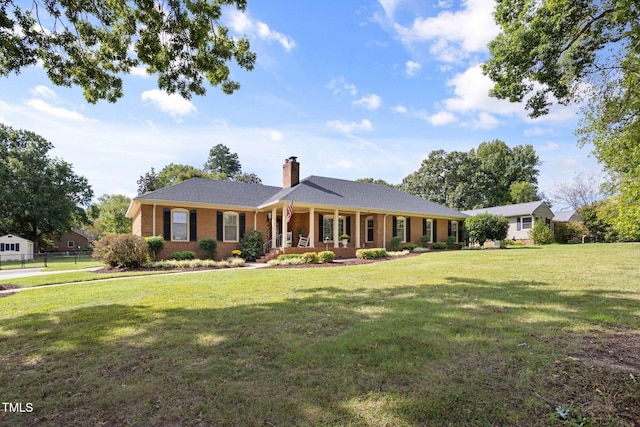 ranch-style house with a front lawn and covered porch