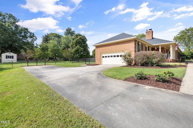 view of front of home featuring a garage, a front yard, and covered porch