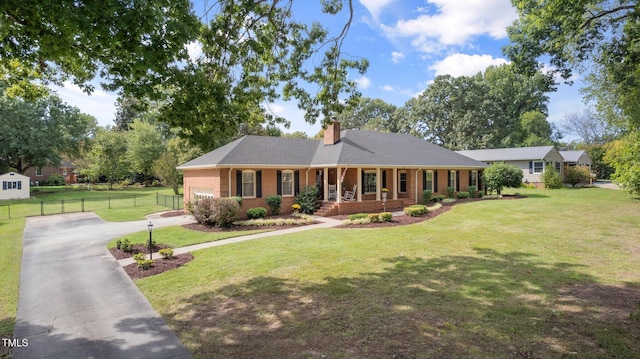 single story home featuring a porch and a front yard