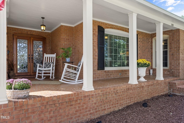 entrance to property featuring covered porch and french doors