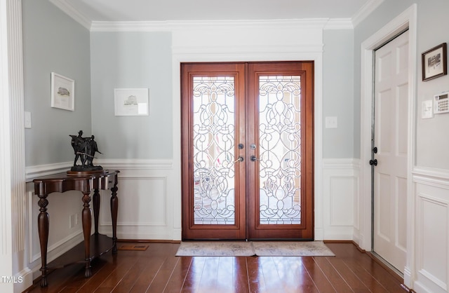 foyer with french doors, crown molding, and dark wood-type flooring