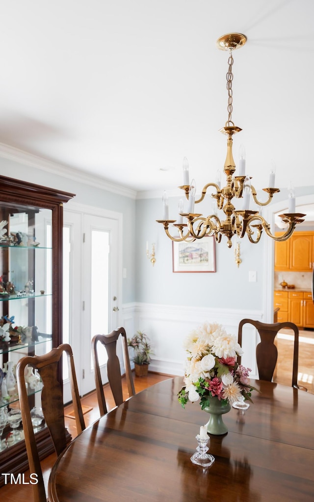 dining space featuring ornamental molding and light hardwood / wood-style floors