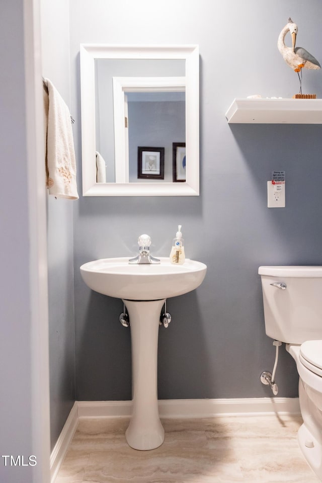 bathroom with wood-type flooring and toilet