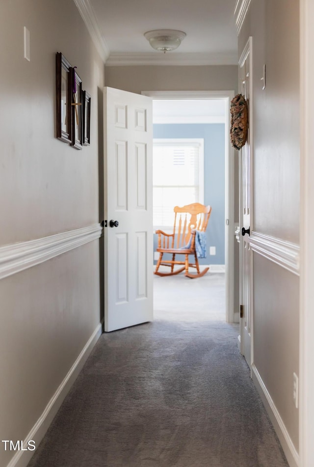 hall featuring dark colored carpet and ornamental molding