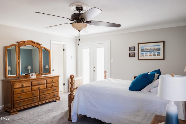 carpeted bedroom with ornamental molding, ceiling fan, and french doors