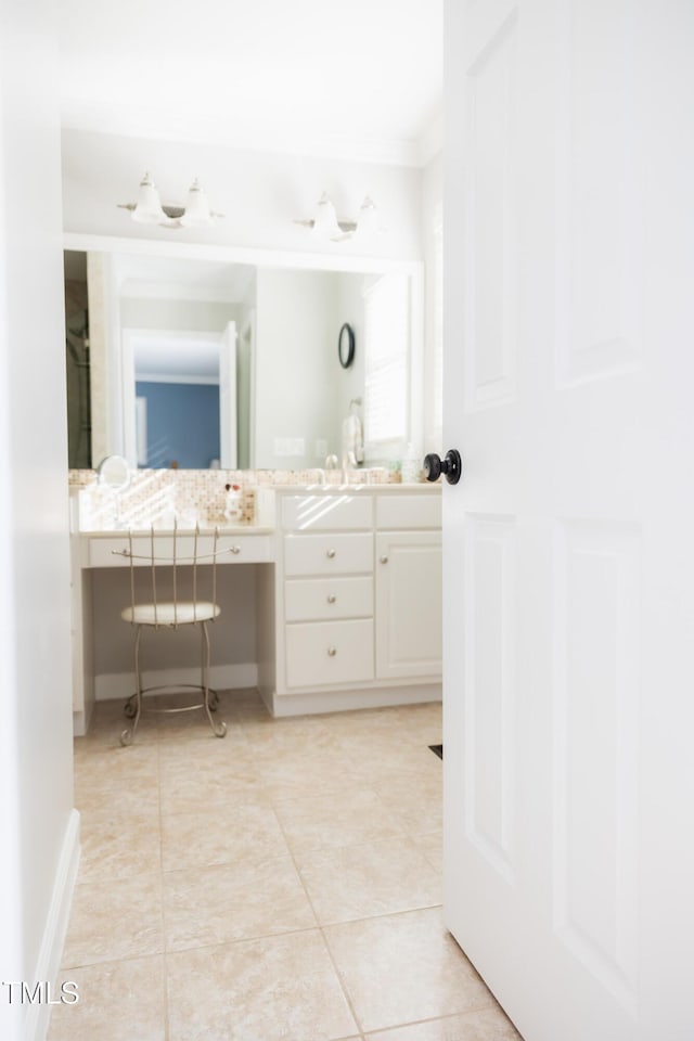 bathroom featuring crown molding, vanity, and tile patterned flooring