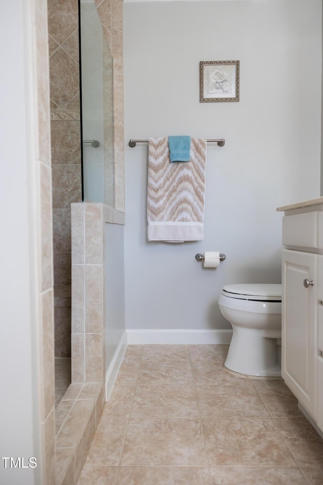 bathroom with toilet, vanity, tile patterned floors, and walk in shower