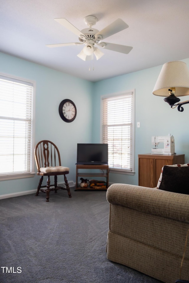 carpeted living room with a wealth of natural light and ceiling fan