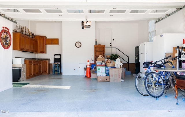 garage featuring a garage door opener and white fridge