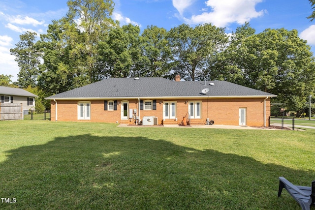 back of house featuring a yard and a patio area